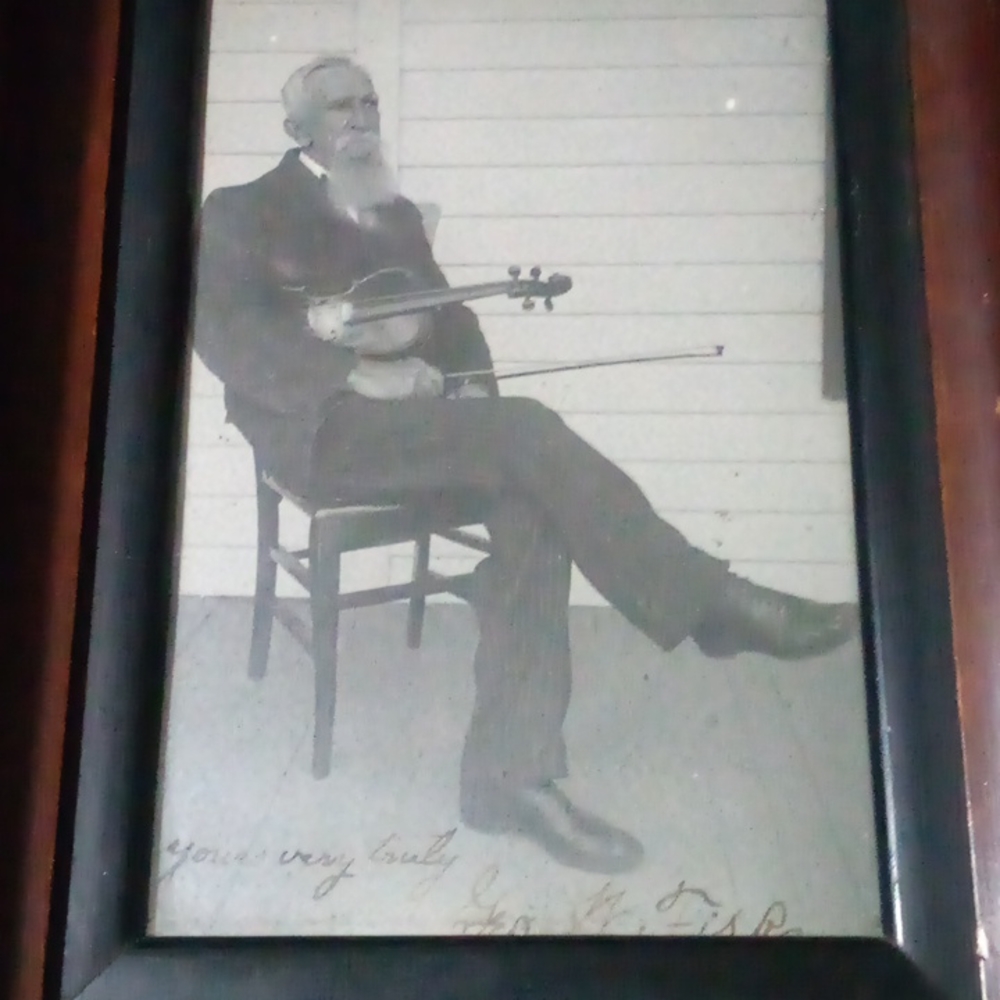 Signed picture of George W Fisk with Fisk violin on his porch in Greeley Colorad